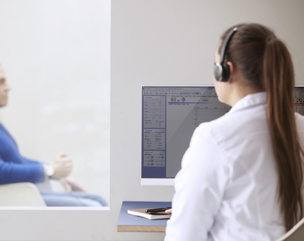 audiologist conducting a hearinf test with a patient